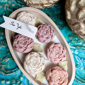 Świeca sojowa beżowe piwonie w pastelowym pojemniku. Świeca z kwiatami.